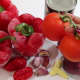 Clockwise from top right: Tomato purée, onion, fresh plum tomato, ginger, garlic, habanero pepper, and bell pepper