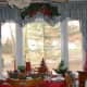 A simple swag centered over the curtain with no wall items to take away from the view. The outside appears to be drawn into the room making it an elegant but cozy environment on a cold winter's day.