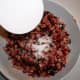 Add 1/2 cup of sugar, and stir until cranberries are lightly coated.