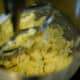 Add in sugar with extracts and combine until mixed.