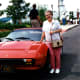 My mother is standing next to Yakov's Ferrari parked just outside the theater.