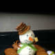 A jaunty cheeseball snowman with crackers for a hat