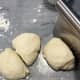 Transfer the dough onto a lightly floured counter or dough mat. Use the dough scraper to divide dough into four equal pieces.