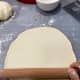 Use a rolling pin to roll one of the dough balls into a thin,10-inch circle. 