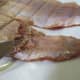 Scrape and remove the darkened areas from the fish