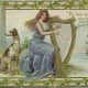 Vintage greeting card: Pretty woman dressed in blue gown playing a gold harp in front of Irish sea scene