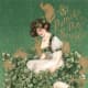 Vintage St. Patrick's Day greeting card: Pretty woman sitting in a bouquet of shamrocks 