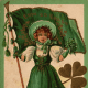 Vintage greeting card: Pretty woman dressed all in green and holding Irish flag for St.Patrick's Day