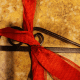 Secure ribbon to the frame with a piece of floral wire.