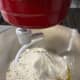 In a stand mixer with a hook attachment, combine the flour, sugar, yeast, water, milk and melted butter. Beat on a lower speed to blend.