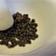 Place the green peppercorns in a mortar and pestle.