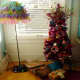 Bring in the Christmas spirit with a tinsel tree set into an upcycled DIY painted hose reel used as a tree base.