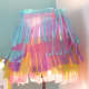 Embellish a white lampshade with rows of colored tissue paper cut into fringed lengths. Layer the tissue paper to achieve a petticoat effect.