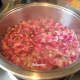 Simmering rose petals and distilled water mixture.