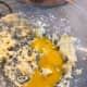 Add the egg yolks all at once in the butter mixture and beat until well combined.
