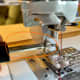 Remove the regular pressure foot holder and screw on the walking foot with its clip.