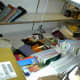 The half empty shelf is part of only one of about seven along that wall. Some of the shelves were damaged and could not be fixed. As you can see, many of them dumped at least part of their contents.