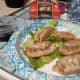 Cooked potstickers on a bed of romaine