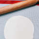Use a rolling pin to stretch the dough.