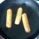 Frying coriander and chilli vegan sausages