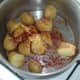 Butter and smoked paprika are added to boiled potatoes