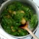 Wilted spinach is stirred through potatoes