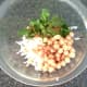 Mixing spicy chickpea and white turnip salad