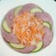 White turnip and carrot salad are arranged in the centre of the plate.