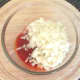 Chopped onion is added to the spicy sauce.