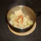 Butter and seasoning are added to vegetables for mashing