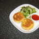 Fish cakes are plated and ready to be garnished for service