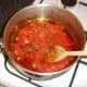 Chopped tomatoes are added to the curry paste