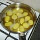 Potato halves are given first fry