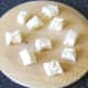 Bread with crusts removed is chopped in to one inch cubes