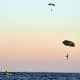 Navy SEALs and special warfare combatant-craft crewmen parachute during a maritime craft aerial deployment system exercise off the coast of Fort Walton Beach Florida.