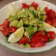 Eggs with fresh avocado and tomato on lettuce