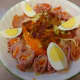 Boiled eggs, shredded carrots, rolled luncheon ham on salad greens