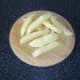 Potato slices are chopped in to chip shapes