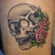 skull tattoos and flowers