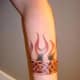 This tattoo incorporates flames and Celtic knots.