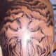 Many fire and flame tattoos incorporate other symbols, like the cross.