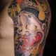 Another shoulder tattoo of a hannya mask.