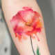 An elegant watercolor-inspired rose tattoo.