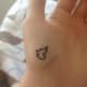 Minimal semicolon-butterfly tattoo