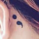 Behind-the-ear semicolon tattoo