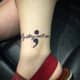 Text semicolon tattoo: "My story isn't over"