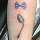Symbolic semicolon made of a bow and a spoon tattoo