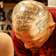 Text tattooed on scalp.