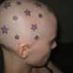 tattooed stars on a person's head