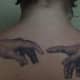 Tattoo inspired by Michelangelo's painting of God and Adam's hands on the ceiling of the Sistine Chapel